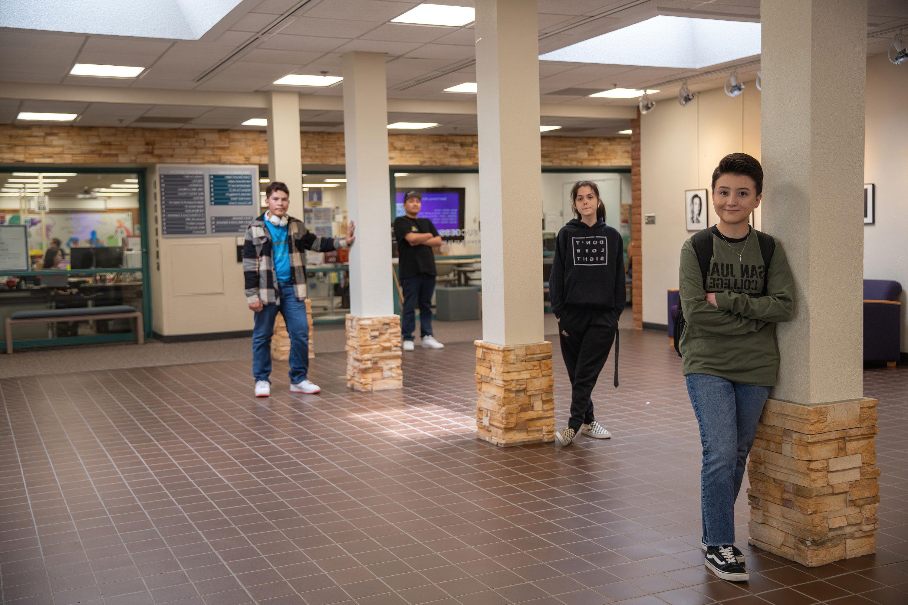 Four students standing by pillars in front of the SJC Tutoring Center